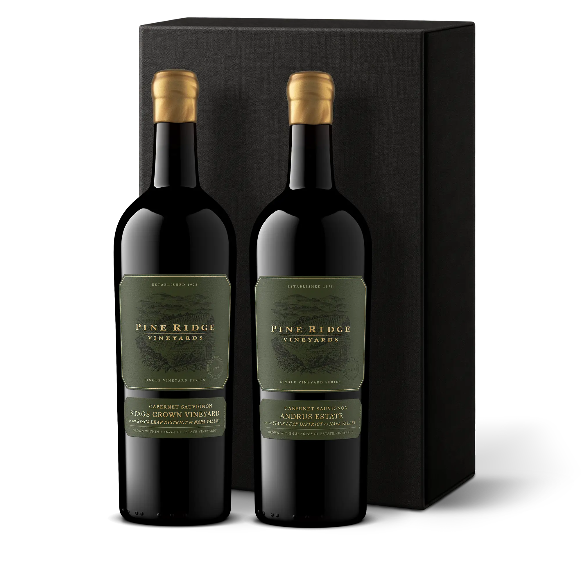 Two bottles of Pine Ridge Vineyards red wine with gold foil tops stand in front of a plain black gift box, creating a striking Napa Valley Favorites 2-Bottle Gift. The labels read Stags Crown Vineyard and Andrus Estate, and both bottles feature dark green labels.