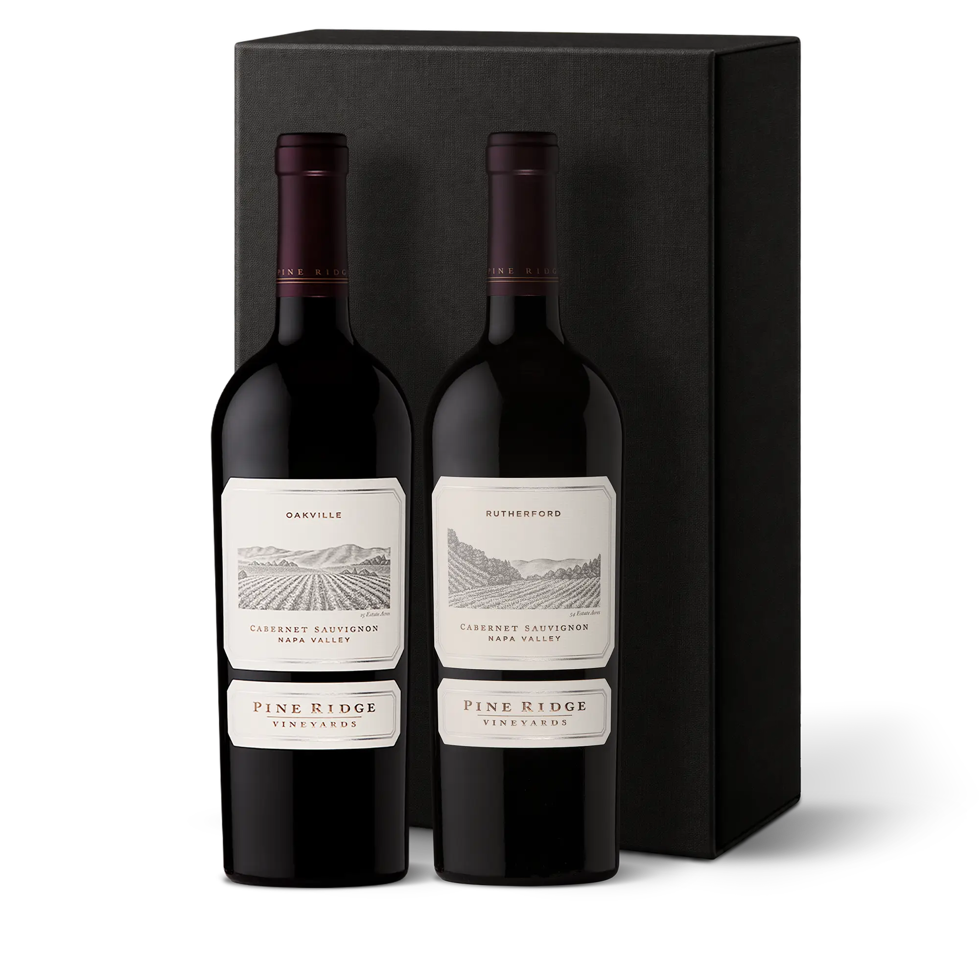 Two bottles of Pine Ridge Vineyards Cabernet Sauvignon wine, labeled Oakville and Rutherford, stand side by side in front of a tall, rectangular black box—creating an elegant Bordeaux Luxe Wine Gift perfect for any occasion.