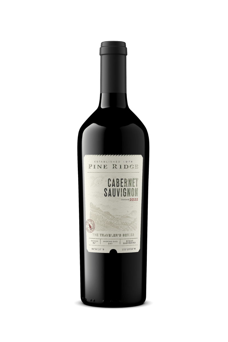 A bottle of Pine Ridge Cabernet Sauvignon 2022 wine. The label is white with text and a logo. The bottle is dark with a black foil covering the neck and cork.