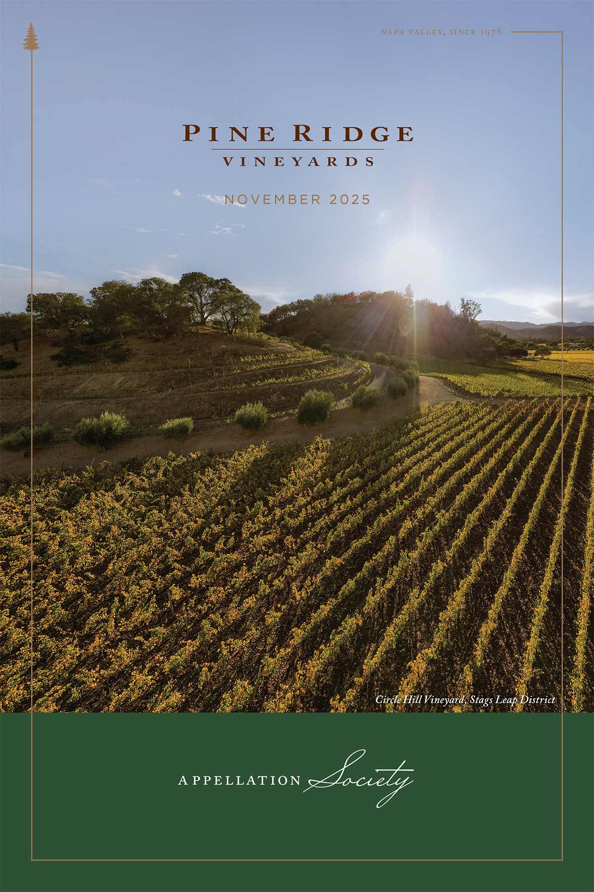 A vineyard with rows of grapevines stretches across gently rolling hills under a partly cloudy sky. Text reads: Pine Ridge Vineyards, November 2025, Appellation Society, Napa Valley, since 1978. Crest Hill Vineyard, Stags Leap District.