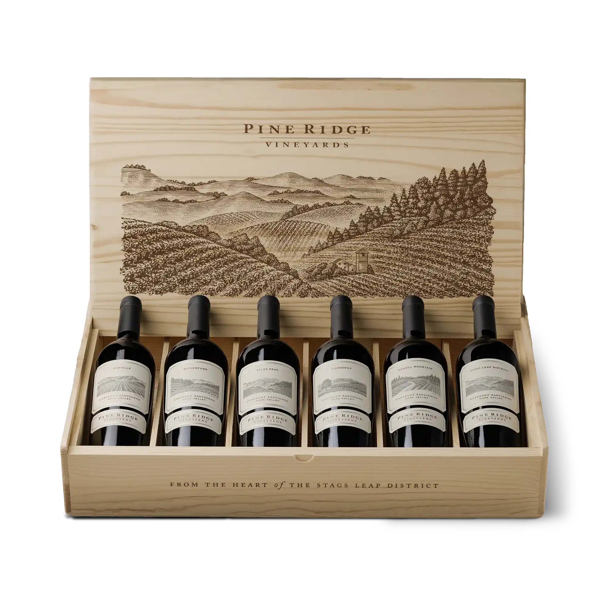 A wooden box with six bottles of Pine Ridge Vineyards red wine from the 2022 FORTIS 6-Bottle Collection, each labeled and laid on its side. The box lid is open, displaying an illustration of vineyard hills and trees above the bottles.